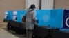 FILE - A Georgia voter marks a ballot during the first day of early voting in the U.S. Senate runoffs at the Gwinnett County Fairgrounds, in Atlanta, Georgia, Dec. 14, 2020.