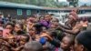 People who fled Goma, Congo, gather at a food distribution point May 28, 2021, in Sake.