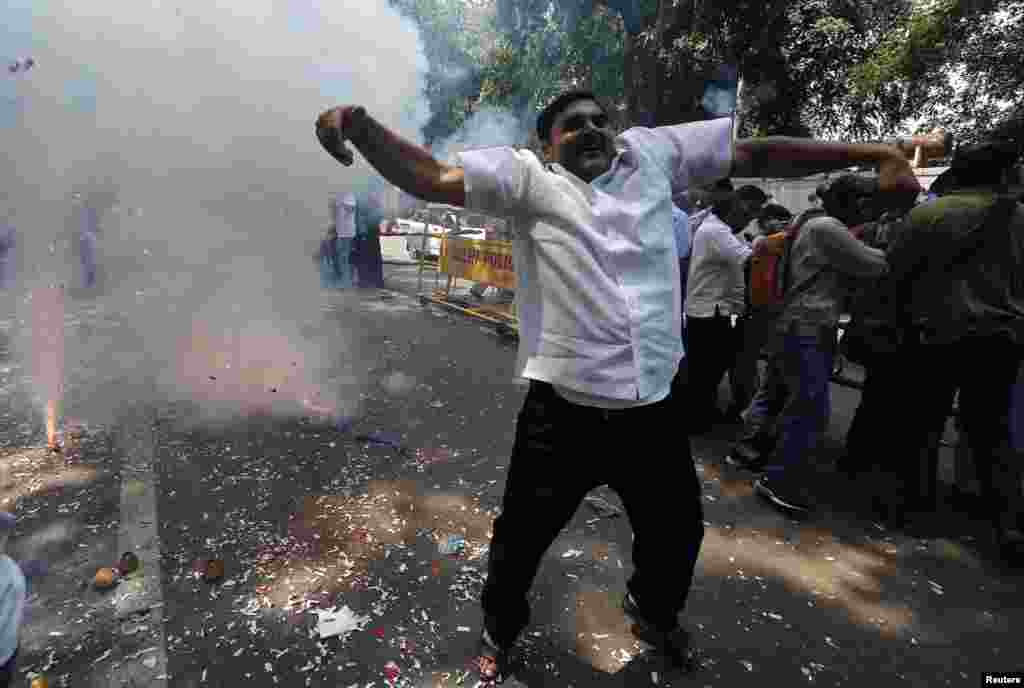 A supporter of India's Bharatiya Janata Party (BJP) celebrates after learning of the early poll results outside party headquarters in New Delhi, May 16, 2014.