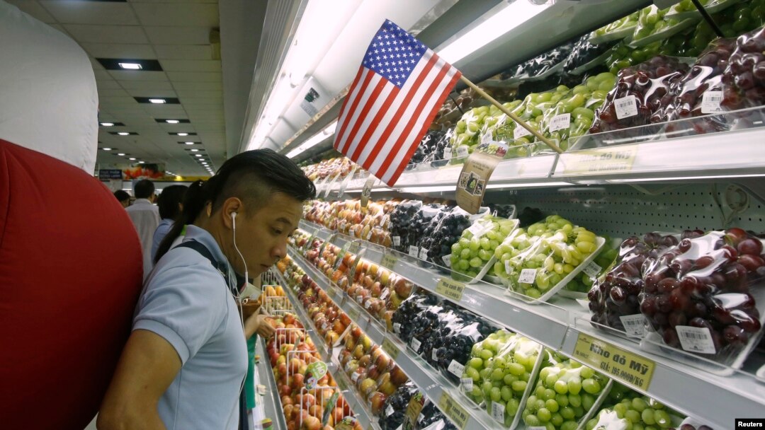 FILE - A man stands at a fruit section of a supermarket in Hanoi, Vietnam, Sept. 20, 2014. 