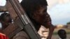 FILE - A man from the Luo Nuer tribe carries his gun in Yuai Uror county, South Sudan.