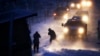 FILE - Cars line up at an exit ramp covered in snow in Cannon Ball, North Dakota, Dec. 6, 2016. Heavy snow, freezing rain and bitterly cold winds hit the state again Monday.
