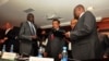 Nhial Deng Nhial, 2nd left, the head of South Sudan's negotiating team, and top negotiator for the rebel's side, Taban Deng Gai, right, a general in South Sudan's army before he defected, sign a cessation of hostilities agreement on Jan. 23, 2014.