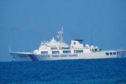 A Chinese Coast Guard patrol ship is seen at South China Sea, in a handout photo distributed by the Philippine Coast guard, April 15, 2021.