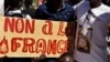 FILE - Demonstrators hold a placard that reads "No to France" during a protest calling for the departure of French forces from Burkina Faso, in the capital Ouagadougou, Nov. 16, 2021.