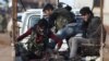 FILE - Free Syrian Army fighters ride on a pick-up truck with a fellow fighter, who was injured during an offensive, on the outskirts of the northern Syrian town of al-Bab, Jan. 10, 2017. The FSA now faces a supply cut-off of the few arms the U.S. did provide for the group.