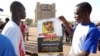 FILE - Demonstrators hold a poster with a portrait of late journalist Norbert Zongo during a protest in Ouagadougo.