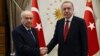 Devlet Bahceli, left, leader of Nationalist Movement Party, or MHP, and the main ally of Turkey's President Recep Tayyip Erdogan, right, shake hands before a meeting at the presidential palace in Ankara, Turkey, June 27, 2018.