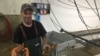 Lobsterman Tom Martin checks his traps off Casco Bay on the Southern coast of Maine. (J. Taboh/VOA News)