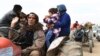 This photo released on March 7, 2018 by the Syrian official news agency SANA, shows Kurds fleeing from their villages where Turkish forces and Syrian rebels battle against Kurdish fighters, in Afrin, northern Syria. 