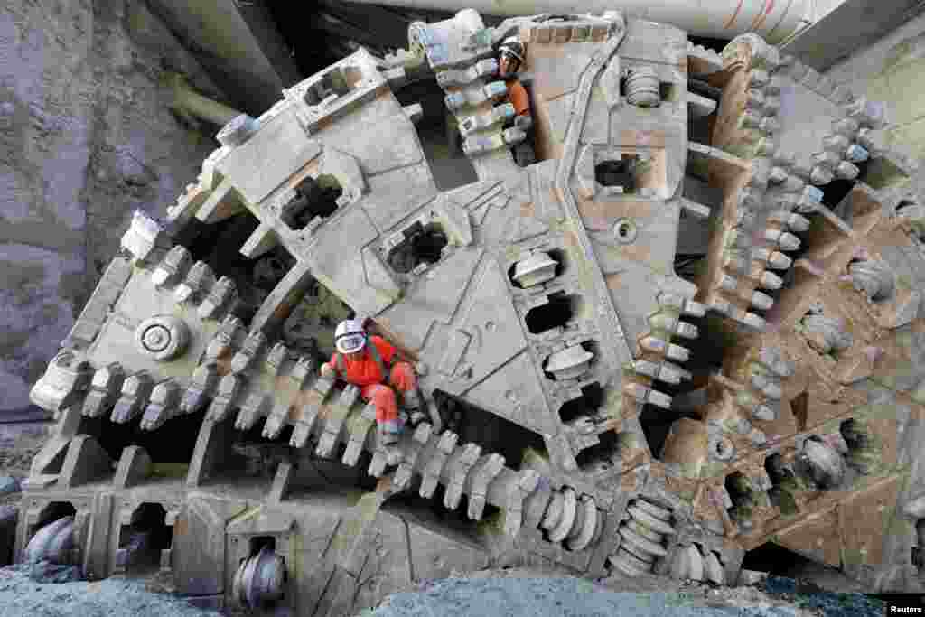 Workers climb out from a tunnel boring machine (TBM) during the breakthrough of a tunnel for the future tramway line in Nice, France.