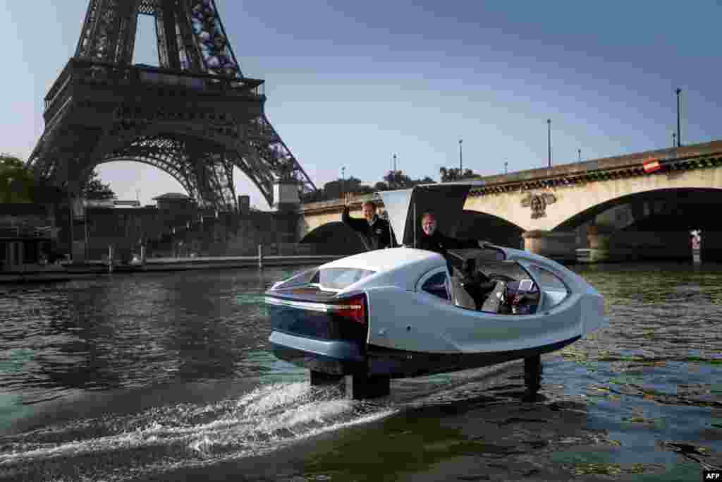 Sea Bubbles start-up founders Alain Thebault (L) and Anders Bringdal (R) stand on board a Sea Bubble electric maritime &quot;flying taxi&quot; during a demonstration on the river Seine in Paris, France.