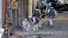 French forensics police search for evidence outside a building in Saint-Denis, where special forces raided an appartment, hunting those behind the attacks that claimed 129 lives in Paris last week, Nov. 18, 2015.
