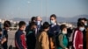 Greek Prime Minister Kyriakos Mitsotakis, right, and German Ambassador to Greece Ernst Reichel, attend the departure of a group of migrant minors from Greece to Germany, at Eleftherios Venizelos International Airport in Athens, April 18, 2020.