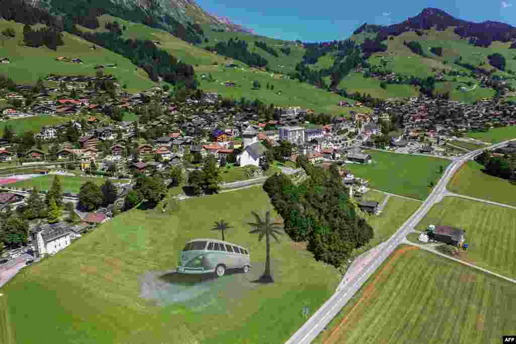 This handout picture provided by French artist French artist Guillaume Legros, also known as Saype, shows a giant land art painting of 4,200 square meters of the legendary Volkswagen Type 2 or VW Kombi created by the artist in Chateau d'Oex, canton of Vaud in Switzerland.