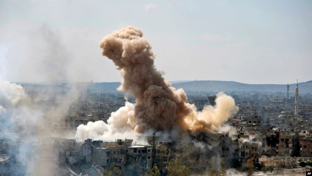 In this photo released by the Syrian official news agency SANA, smoke rises after Syrian government airstrikes and shelling hit in Hajar al-Aswad neighborhood held by Islamic State militants, southern Damascus, April 22, 2018.