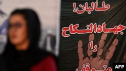Afghan women take part in a gathering against the claimed human rights violations on women by the Taliban regime in Afghanistan, at a hall in Kabul, Aug. 2, 2021 